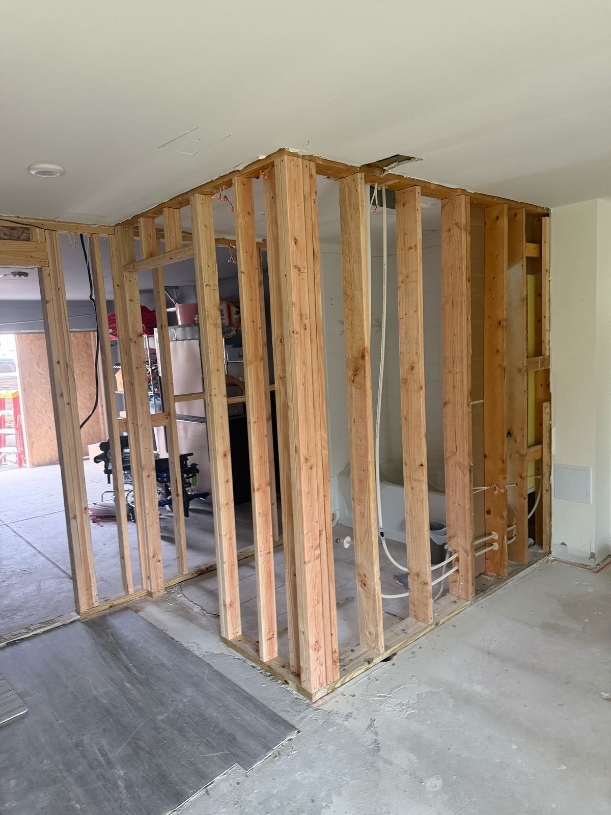 New interior stud wall framing with plumbing lines run for an adjoining bathroom
